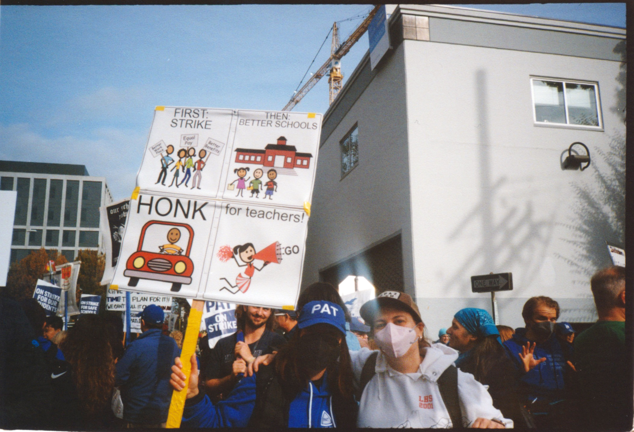 TWO WOMEN POSE WITH A PICKET SIGN 
