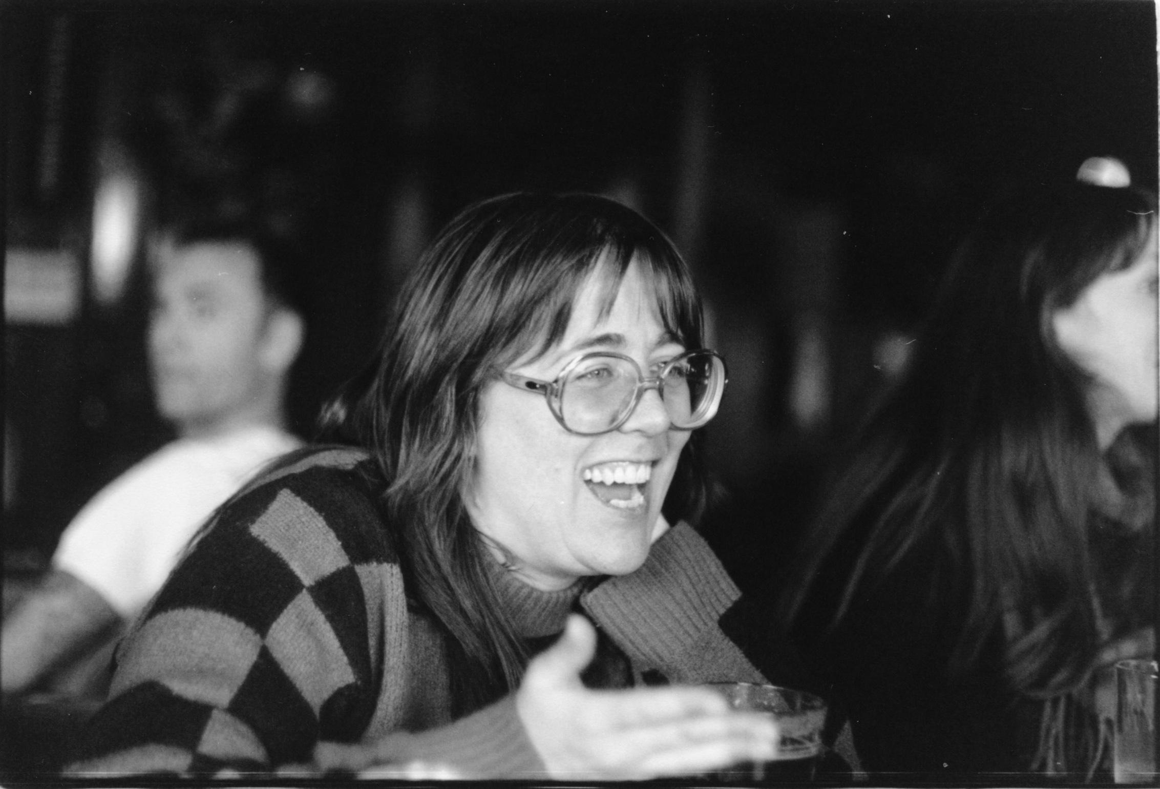 A BLACK AND WHITE PORTRAIT OF A WOMAN DISHING AT THE BAR
